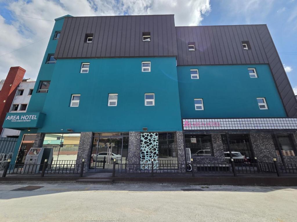 a blue building with a black roof at AREA HoTEL in Yeongju