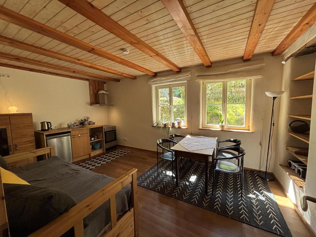 a bedroom with a bed and a table and chairs at Auf der Saarinsel in Kanzem