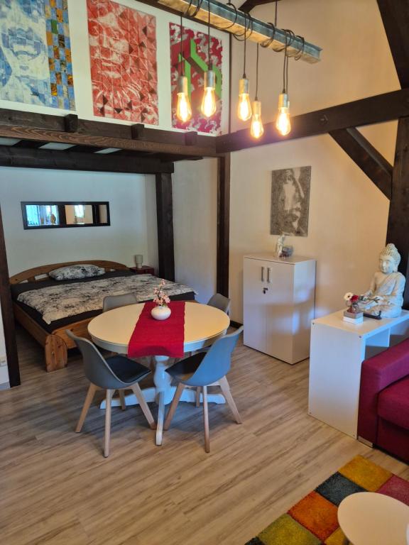 a room with a table and chairs and a bed at Ferienwohnung Atelier in Siegsdorf