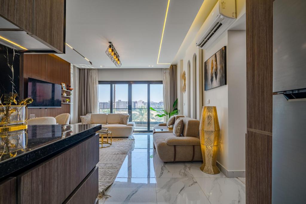 a living room with a couch and a table at Luxury Smart Home Entire Apartment with 2 Bedrooms in Madinaty in Madinaty