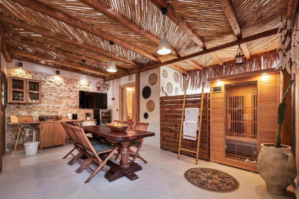 a dining room with a wooden table and chairs at Diastar Boutique in Heraklio