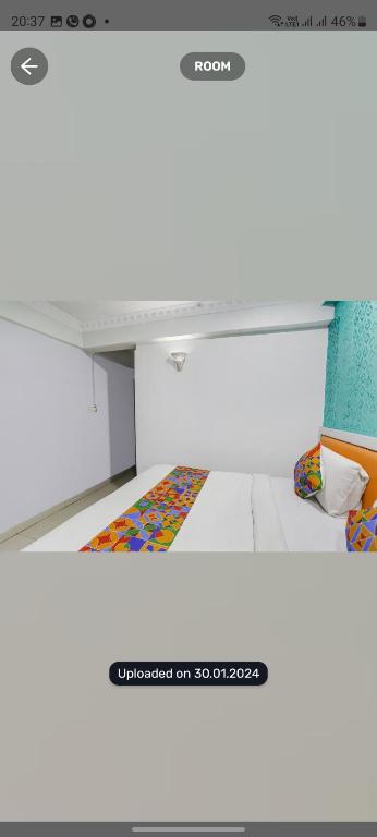 a white bench with a colorful rug under it at Hotel Sonali Regency in Bhopal