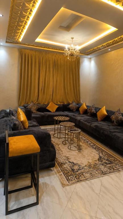 a living room with couches and tables in a room at Lux New Apartment in Mrhila