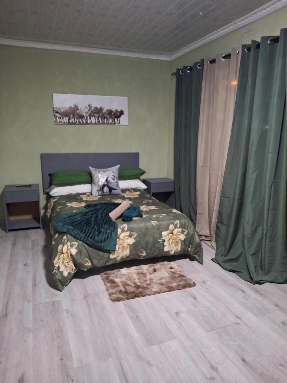a woman laying on a bed in a bedroom at Jacaranda Bnb in Khayelitsha