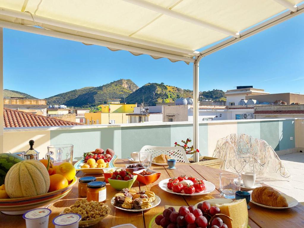 a table with a bunch of fruits and vegetables on it at Solemar Sicilia - Casa Enza in Santa Flavia