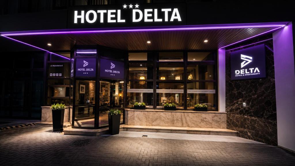a hotel delia facade at night with purple lights at Hotel Delta in Krakow