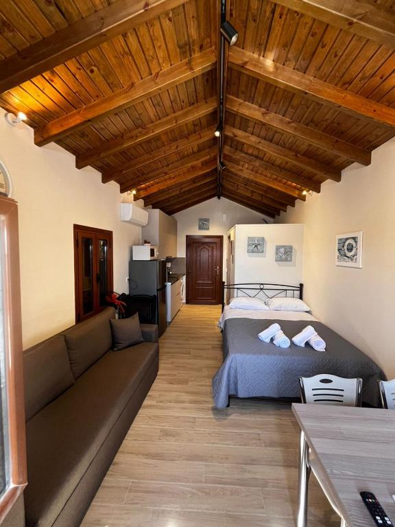 a living room with a bed and a couch at Limanaki 1 in Chios