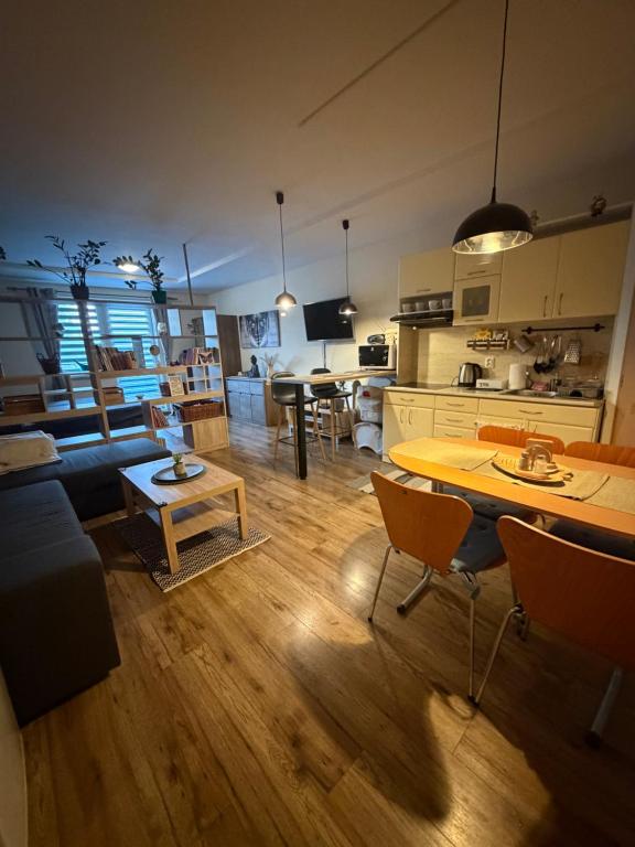 a living room with a kitchen and a dining room at Apartman BibKa in Donovaly