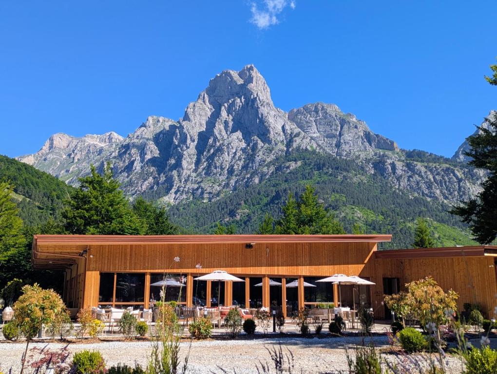 a building with a mountain in the background at AMZA Valbona Mountain Retreat in Valbonë