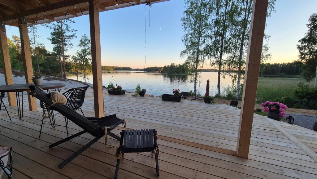 a screened in porch with a view of a lake at Sauna by Lake Saimaa in Savonlinna
