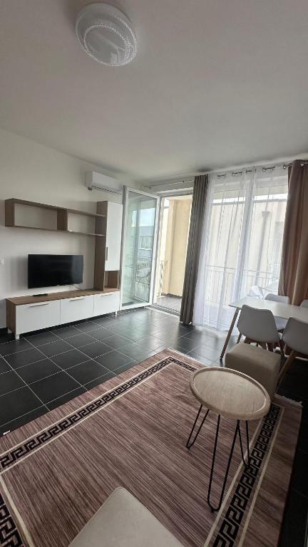 a living room with a couch and a table and chairs at Tale Coast Apartments in Tale