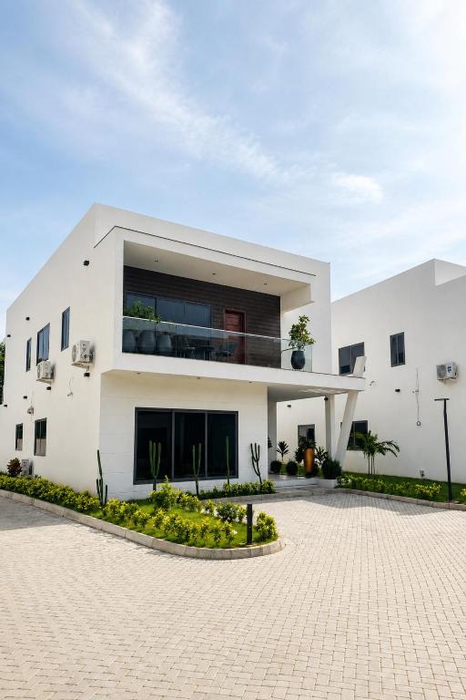 a large white house with a courtyard at Luxury Villa at THE HIDDEN DOMUS I Trassaco, East Legon in Accra