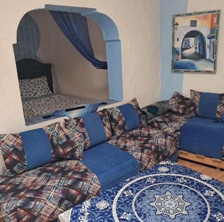 a living room with a couch and a bed at Bleu Chefchaouen in Chefchaouen