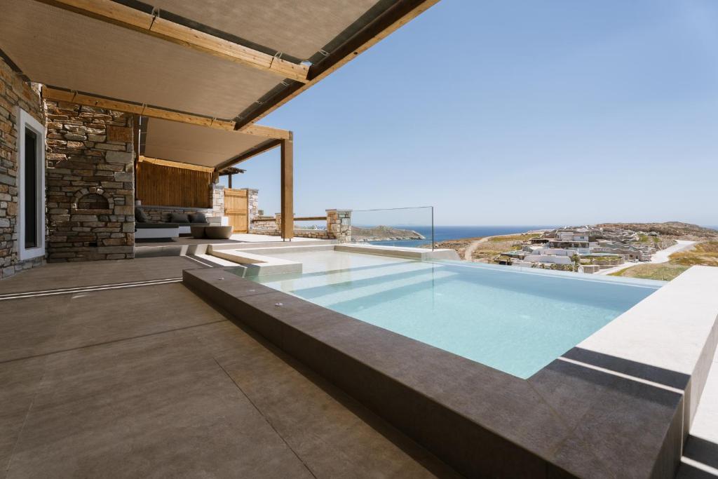 an indoor swimming pool with a view of the ocean at Ios Sea view apartment with pool 2B in Ios Chora