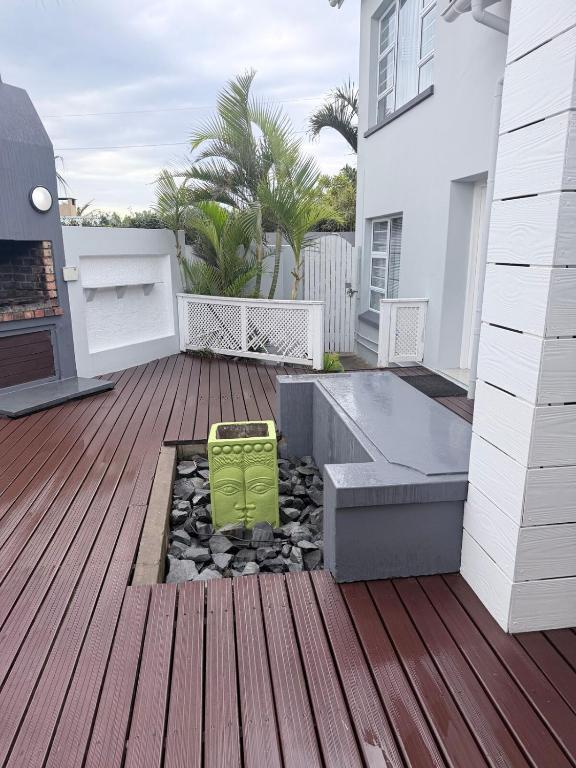 a deck with a bench and a fire place at CCV Beach House in Bay View