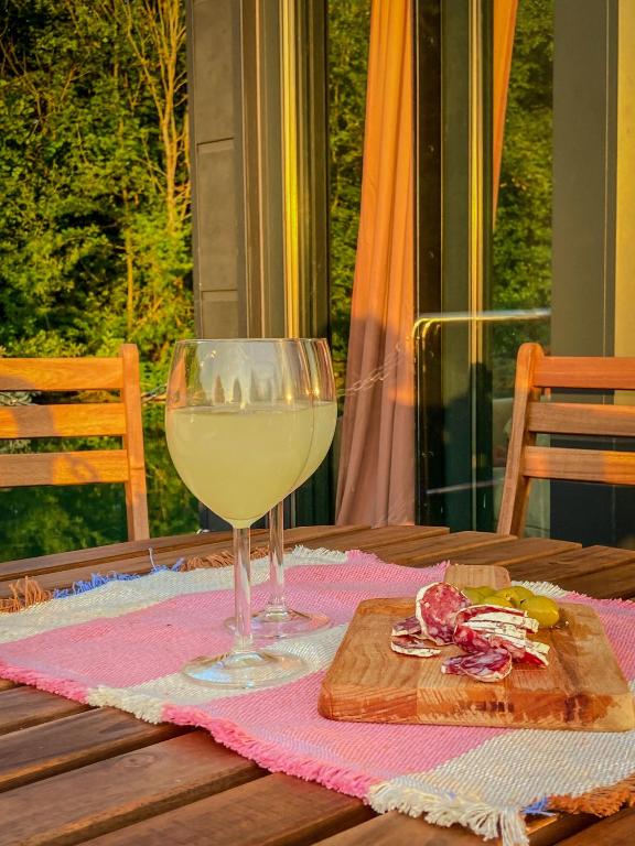 a glass of white wine sitting on a table at Houseboat - Suite Aurore in Honfleur
