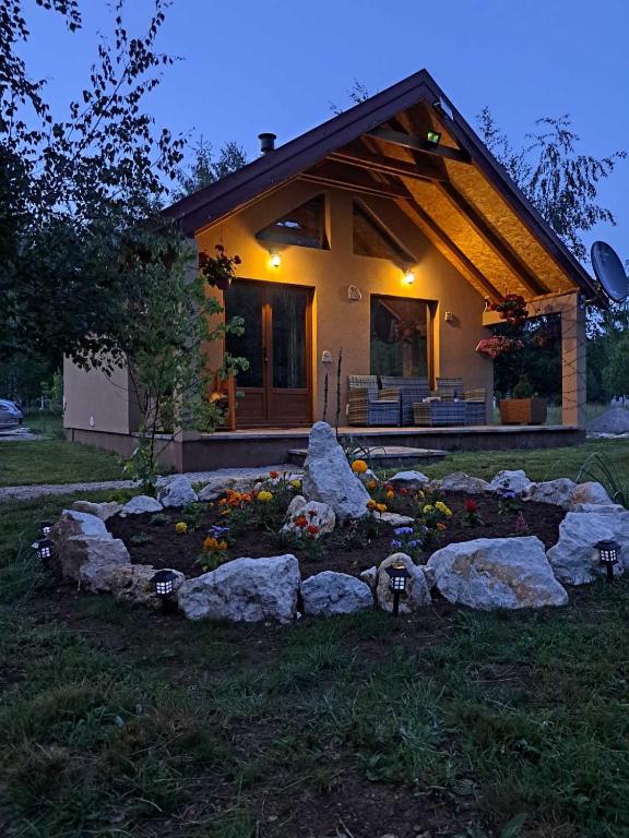a house with a bunch of rocks in front of it at House 28 Brezna in Plužine