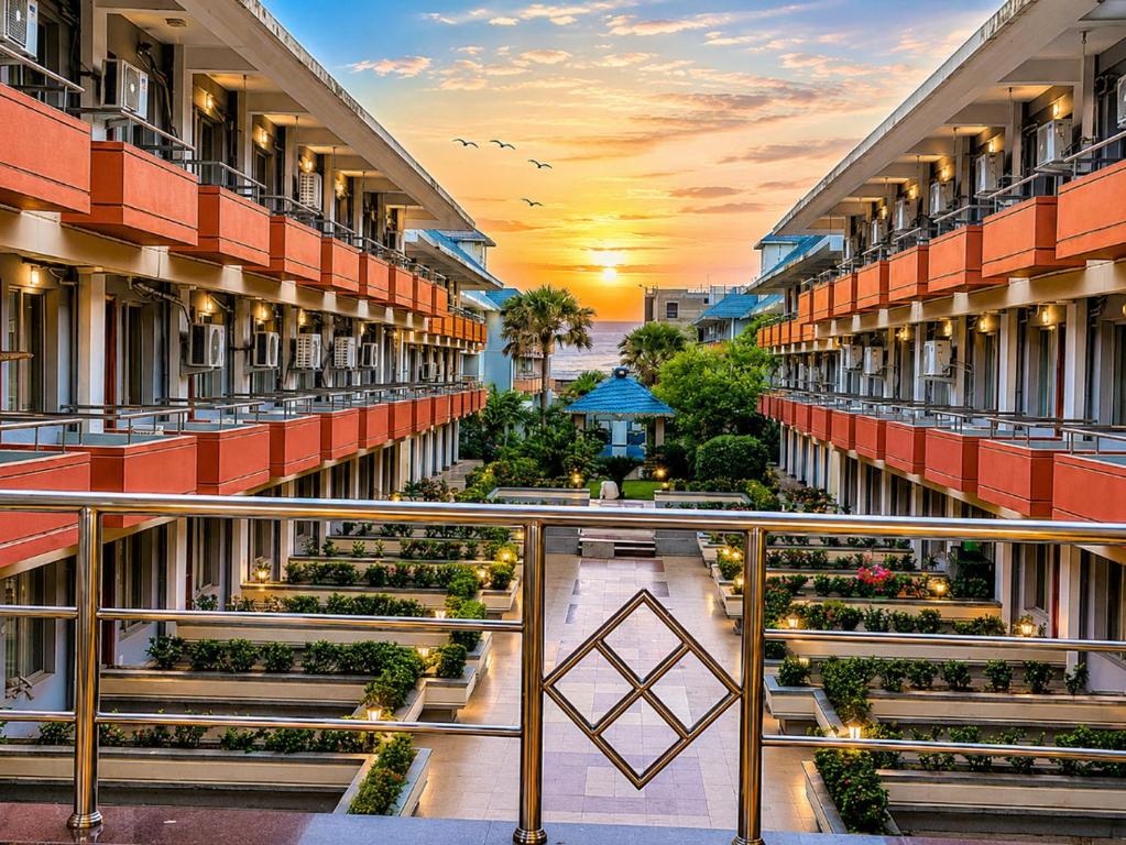a view from the balcony of a building with plants at Blue Lily Beach Resort in Puri