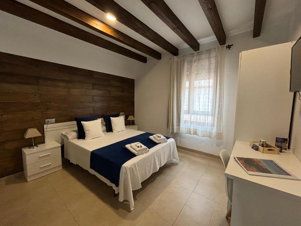 a bedroom with a large bed and a window at habitaciones tabarca in Tabarca
