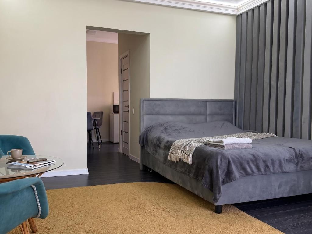 a bedroom with a bed and a table and a chair at new stail centr in Bălţi