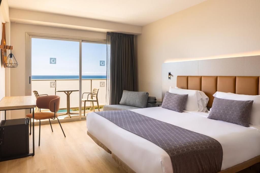 a hotel room with a bed and a balcony at htop Pineda Palace SPA 4Sup - Bliss - Adults Only Plus 18 in Pineda de Mar