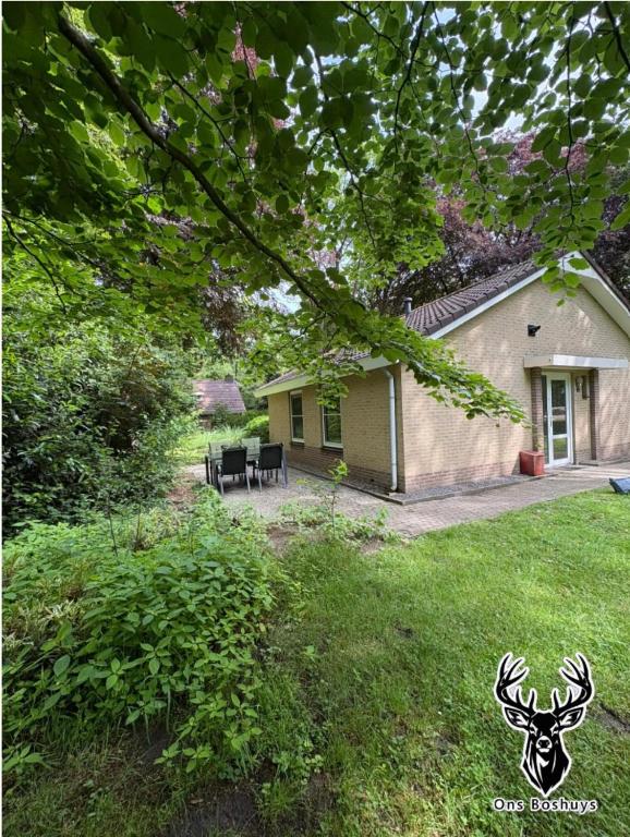 a house with a reindeer sign in the yard at Ons Boshuys C18 in Garderen