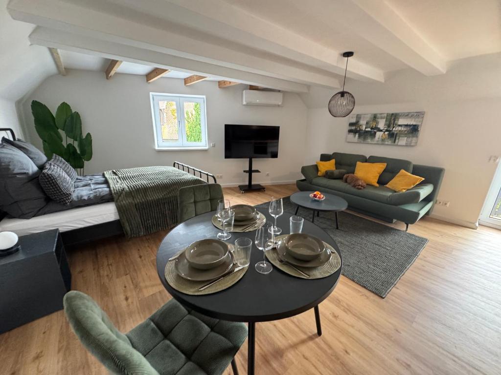 a living room with a table and a couch at Steigerwald Habitat in Oberschwarzach