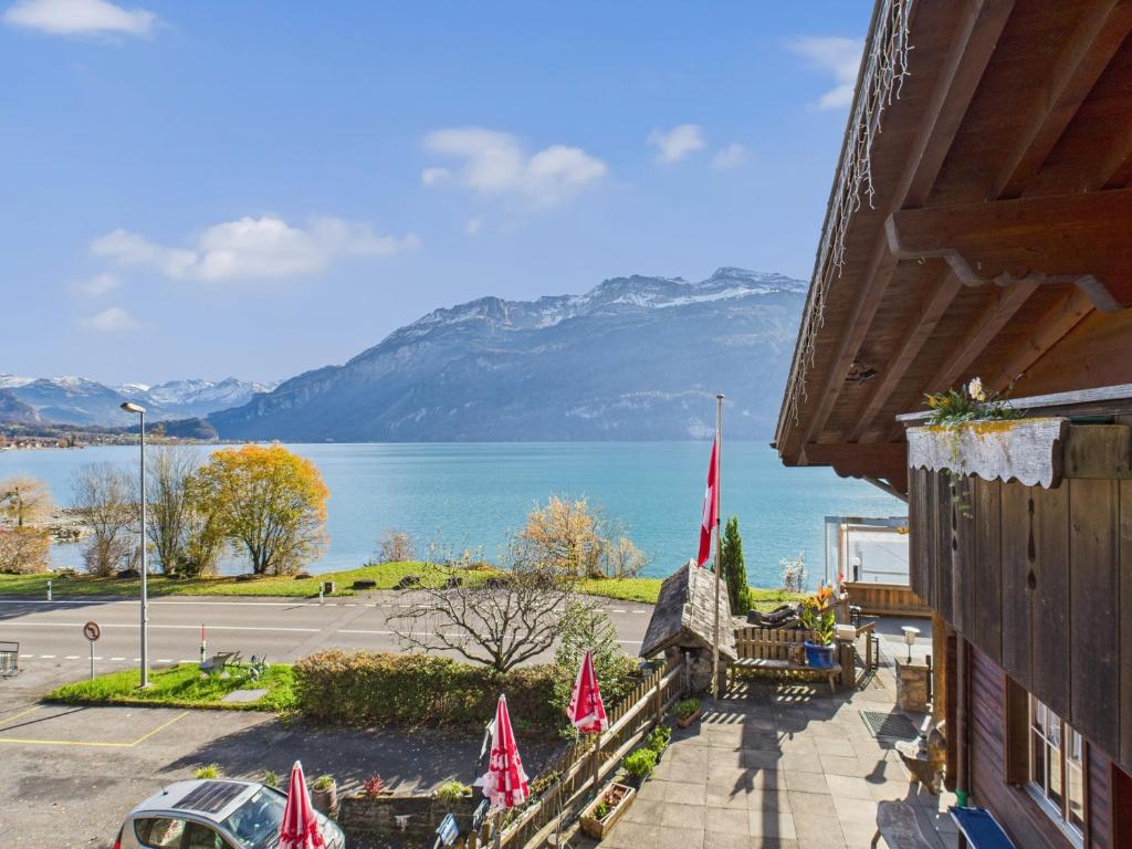 a building with a view of a lake and mountains at Hotel Wildbach Brienz - Self Check-in in Brienz