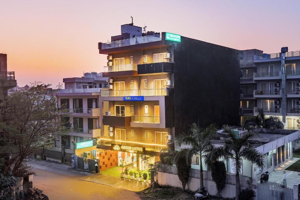 a tall building with a sunset in the background at FabHotel Elvis International in Mumbai