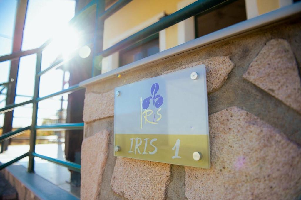 a sign on the side of a building at Iris apartment 1 in Anaxos