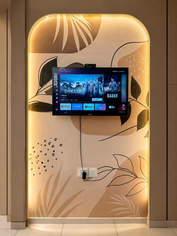 a flat screen tv hanging on a wall at Skyline Zirakpur in Zirakpur