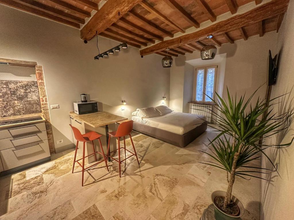 a bedroom with a bed and a table and chairs at La Casina Room in Castelmuzio