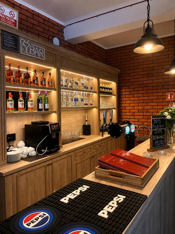 a restaurant with a bar with a table with a sign at Karczma u Jakuba in Domaniów