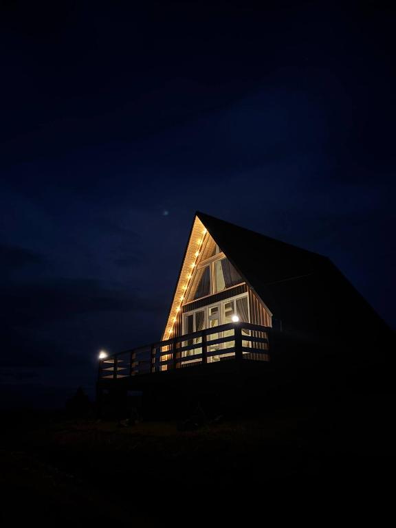 a house with a lit up roof at night at lovelaz820 in Khashchovanoye