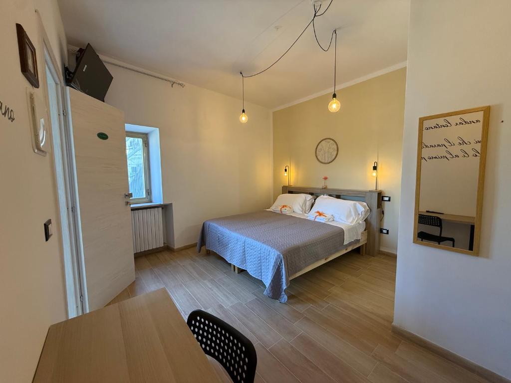 a bedroom with a bed and a table in it at Agrialloggio Supramonte in Barisciano
