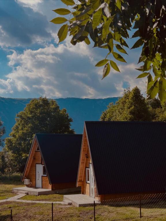 a log cabin with a black roof at Ognjiste Komarnice in Komarnica
