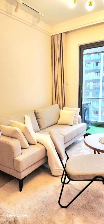 a living room with two couches in front of a window at Artesano A71 in Nairobi