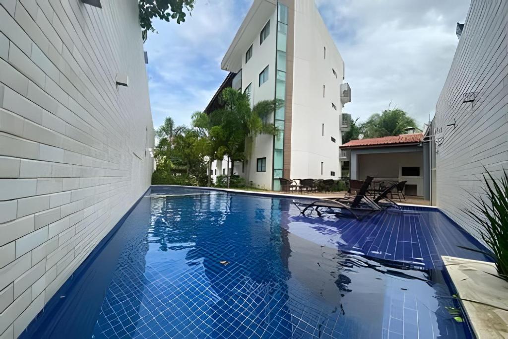 a view of a swimming pool between two buildings at Porto bello condomínio in Porto De Galinhas