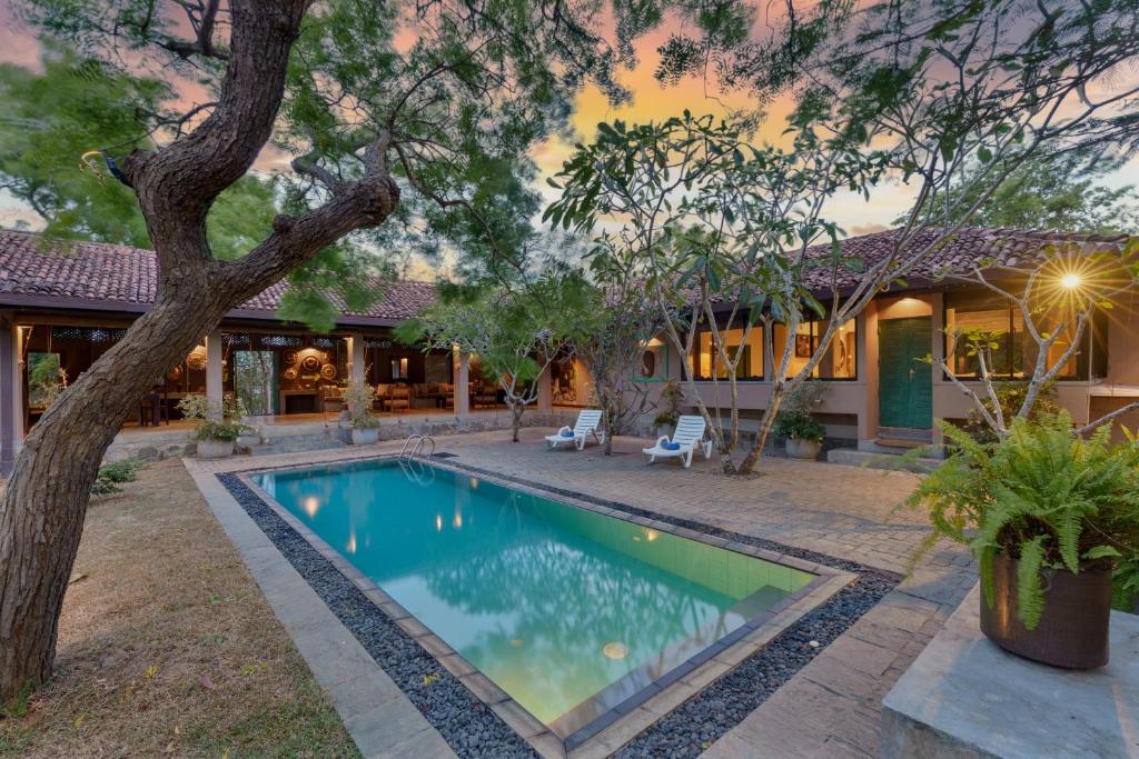 a swimming pool in the yard of a house at Yala Villa in Yala