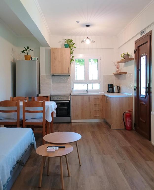 a kitchen with a table and a dining room at Etherio in Makrygialos