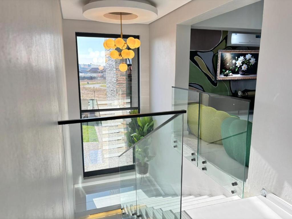 a glass staircase in a house with a window at Zabo Guesthouse in Middelburg