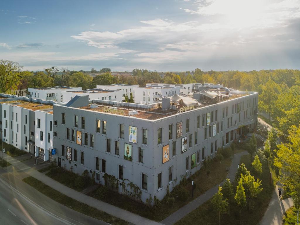 an overhead view of a large white building at Grimm´s Berlin Potsdam in Teltow