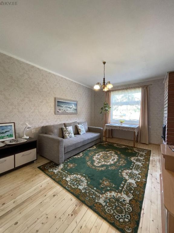 a living room with a couch and a rug at Tulika korter in Paralepa