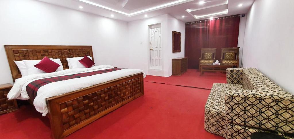 a bedroom with a bed and a chair in it at Villaggio Hotel in Khaplu