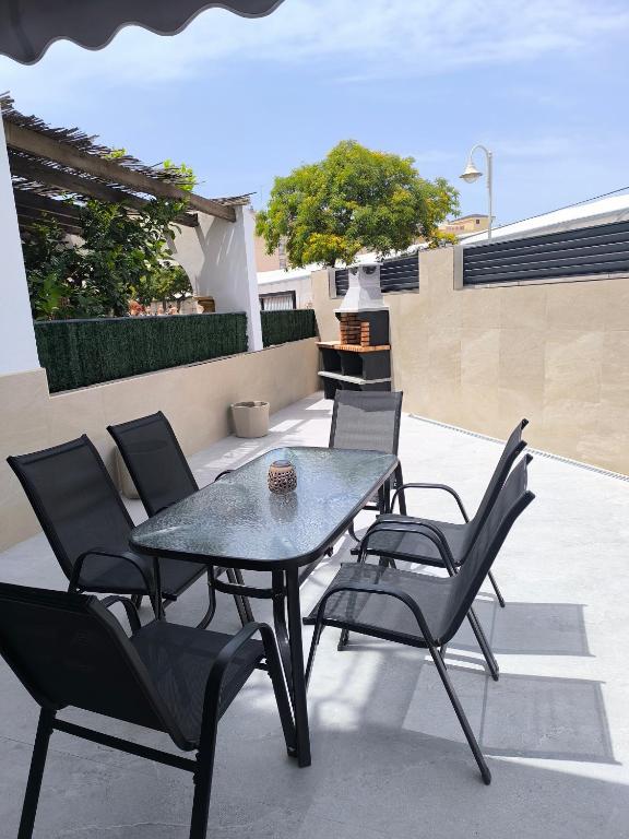 a table and chairs sitting on a patio at Casa Torrox Costa cerca del mar in Torrox