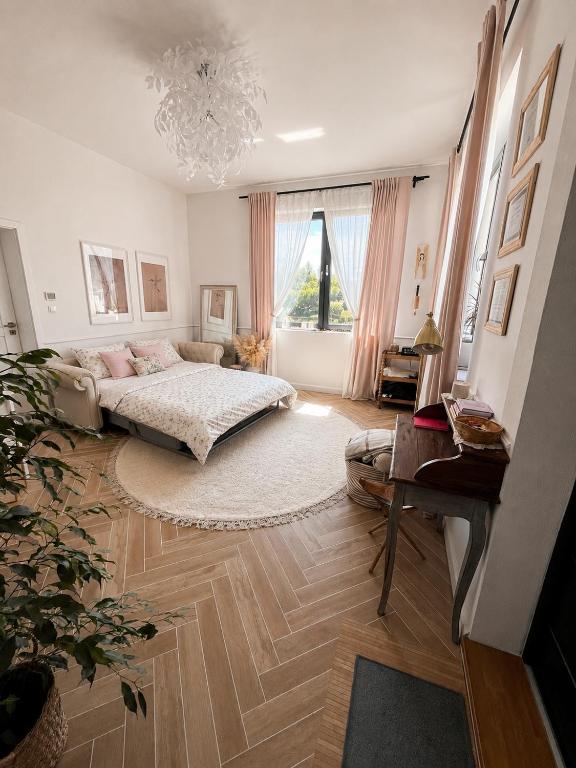 a bedroom with a bed and a large window at LOG apartament in Dobrzewino