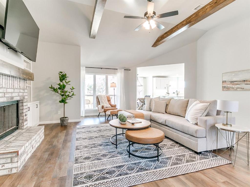 a living room with a couch and a fireplace at New Dream Home in Broken Arrow! in Broken Arrow
