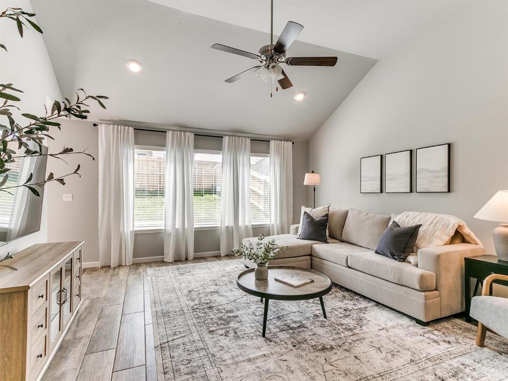 a living room with a couch and a table at Spacious Retreat with Vaulted Ceilings & Primary Suite! in Broken Arrow