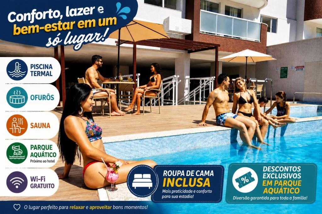 a group of people sitting around a swimming pool at Everest Flat Service in Caldas Novas