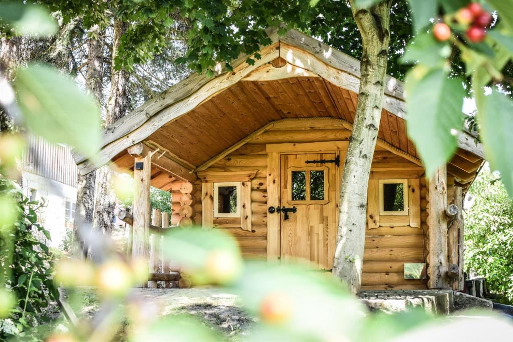 a log cabin with a tree at Berghof Papstdorf in Kurort Gohrisch